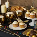 Magical ingredients and wizarding tools displayed on a wooden table with enchanted recipes like Butterbeer, pumpkin pasties, and treacle tart, set in a cozy, mystical Hogwarts kitchen ambiance